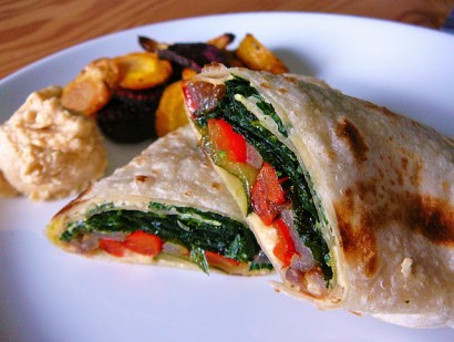 roasted vegetable wrap with oven-fried spinach and caramelized onion hummus
