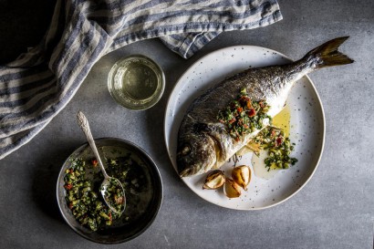 Baked whole fish with lemon, herbs and garlic butter